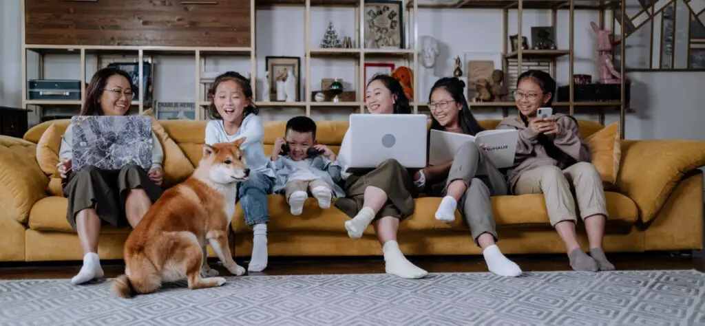 Large family sat on a yellow sofa